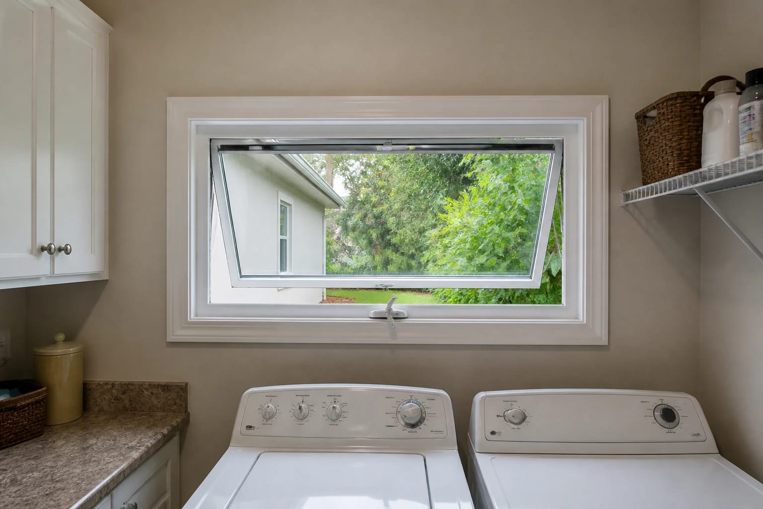 A top-hinged awning window open in a modest Central Florida laundry room